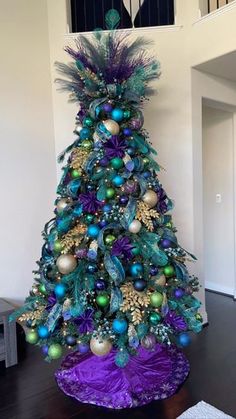 a decorated christmas tree with purple and green ornaments