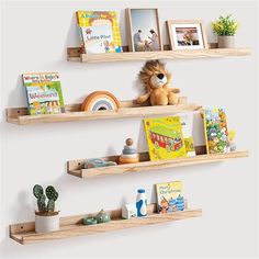 three wooden shelves with books and toys on them