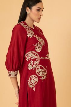 Red chanderi tunic with puff sleeves, placement floral frame pattern, contrast zari, thread, sequin and pearl embroidery. Paired with straight pant.
Components: 2
Pattern: Embroidered
Type Of Work: Thread, Sequin , Zari and Pearl Work
Neckline: Keyhole Round Neck
Sleeve Type: Puff Sleeves
Fabric: Chanderi
Color: Red
Other Details: 
Attached lining
Length:
Tunic: 45 inches
Pant: 40 inches
Sleeves: 18 inches
Weight: 1.5 kgs
Tunic Closure: Front loop button
Occasion: Puja,Work - Aza Fashions Anarkali Embroidered Dress For Festive Occasion, Red Anarkali Set With Floral Embroidery For Festivals, Red Floral Embroidery Anarkali Set For Festivals, Festive Embroidered Dress With Intricate Embroidery, Designer Chanderi Dress With Intricate Embroidery, Festive Raw Silk Dress With Resham Embroidery, Festive Resham Embroidered Raw Silk Dress, Festive Raw Silk Sets With Floral Embroidery, Festive Resham Embroidery Raw Silk Dress