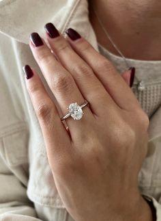 a woman's hand with a diamond ring on it