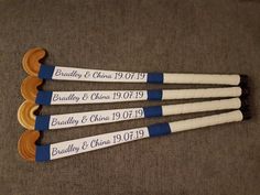 four wooden paddles with names on them sitting on the floor next to each other