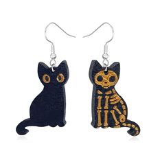 two black and gold cat earrings with skeleton on them