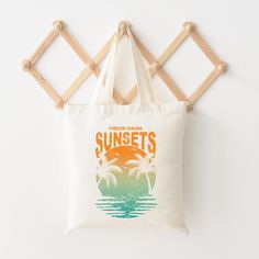 Looking for a cute tote bag to carry all your essentials this summer? This cute Chasing Sunset Vintage bag will be perfect to add to your collection. Perfect for a day at the beach or every day life! Summer Canvas Gift Bag, White Retro Canvas Bag For Summer, Retro Rectangular Summer Canvas Bag, Summer Style Canvas Gift Bag, Retro White Canvas Bag For Summer, White Letter Print Bags For Summer, Retro Summer Travel Canvas Bag, Retro Summer Canvas Travel Bag, Retro Summer Beach Bag For Travel