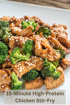 a white plate topped with chicken and broccoli covered in sesame seed flakes