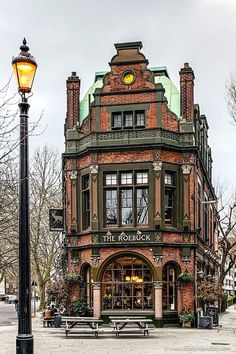 an old brick building with a green roof