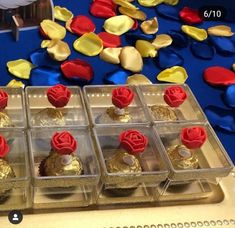 four trays filled with chocolate covered pastries on top of a blue table cloth