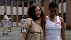 two young women standing next to each other on a basketball court