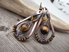 amber bronze earrings with natural tiger's eye stone, wire wrapped jewelry, unique beaded hand forged earrings, boho dangle teardrop, copper by TFUniqueTwists on Etsy https://www.etsy.com/listing/784136589/amber-bronze-earrings-with-natural Wire Wrapped Copper Teardrop Earrings, Adjustable Teardrop Bohemian Wrap Earrings, Bohemian Teardrop Wrap Earrings, Rustic Brown Wire Wrapped Jewelry, Wire Wrapped Copper Teardrop Dangle Earrings, Bohemian Wire Wrapped Teardrop Earrings, Adjustable Wire Wrapped Bohemian Teardrop Earrings, Bohemian Adjustable Wire Wrapped Teardrop Earrings, Unique Hand Forged Brown Earrings