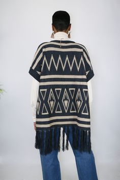 Slide on and go with this easy to wear poncho. She’s understated with neutral colors, but her woven details are what makes her the perfect statement of your look. The tassels are a fun touch and gives her some added length. One size fits most Made of Acrylic One Size Knit Poncho With Fringe, Beige Fringe Poncho For Fall, Beige Fringed Poncho Shawl, Oversized Shawl Poncho With Tassels, Oversized Fringe Cape Poncho, Beige Fringe Shawl Poncho, Oversized Fringe Casual Poncho, Oversized Fringe Poncho Casual Style, Casual Winter Poncho With Tassels