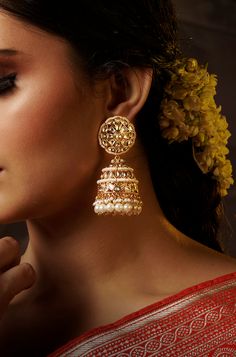 Add a touch of traditional elegance to your ensemble with these dramatic jhumkas in gold, adorned with cascading pearls. Perfect for complementing traditional attire, these earrings exude timeless charm and sophistication. Finish: 22KT Gold Plating Material: Brass, Kundan, Pearls Color: Gold Size: One Size Closure Type: Push Back Box Contains: 1 Pair of Earrings Elegant Jhumkas With Intricate Design For Navratri, Elegant Navratri Jhumkas With Intricate Design, Kundan Jhumkas For Eid Reception, Bollywood Style Jhumkas With Intricate Design For Reception, Festive Intricate Design Jhumkas For Eid, Chandbali Jhumkas For Wedding And Navratri, Wedding Chandbali Jhumkas For Navratri, Wedding Jhumkas With Intricate Design For Eid, Intricate Design Jhumkas For Diwali Reception