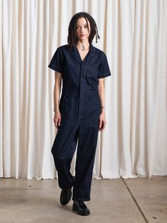 Classic short sleeved boiler suit buttons up front with hidden placket, notch collar and front patch pockets. Includes side tabs with buttons for synching waist. Pre-washed + pre-shrunk. CONTENT + CARE:100% Cotton DenimMachine wash cold, lay flat or hang to dry MEASUREMENTS:XS - Waist: 32", Hips: 37", Inseam: 27.5"S - Waist: 35", Hips: 39", Inseam: 27.5"M - Waist: 37", Hips: 41”, Inseam: 27.5”L - Waist: 38", Hips: 42”, Inseam: 27.5” Utility Style Denim Jumpsuit With Relaxed Fit, Utility Denim Jumpsuit With Short Sleeve And Relaxed Fit, Relaxed Fit Denim Jumpsuit With Short Sleeves And Pockets, Utility Short Sleeve Denim Jumpsuit With Pockets, Utility Denim Jumpsuit With Pockets And Short Sleeves, Utility Denim Jumpsuit With Short Sleeves And Pockets, Utility Style Denim Jumpsuit With Short Sleeves For Work, Short Sleeve Denim Utility Jumpsuit For Workwear, Relaxed Fit Cotton Denim Jumpsuit With Short Sleeves