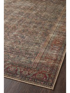 an antique persian rug on the floor with wood floors and dark colored carpeting in front of it