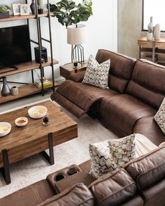 a living room filled with furniture and a flat screen tv sitting on top of a wooden table