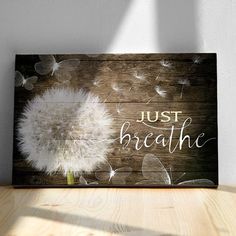 a dandelion sitting on top of a wooden table