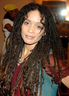 a woman with dreadlocks standing in a room