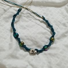 New! Handmade Skull Hemp Bracelet Teal String Natural Colored Hemp Purple/ Green / Teal Pony Beads Silver Skull Bead Closure: Hoop & Tie Handmade Casual Skull Bracelets, Handmade Casual Skull Bracelet, Casual Handmade Skull Bracelets, Casual Blue Jewelry For Festivals, Handmade Adjustable Skull Jewelry, Adjustable Handmade Skull Bracelets, Casual Skull Jewelry For Gifts, Casual Skull-shaped Jewelry For Gifts, Casual Skull-shaped Jewelry Gift