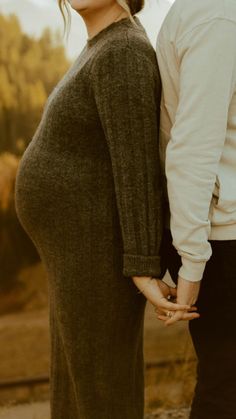 a man and woman holding hands while standing next to each other