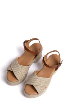 Woven jute amplifies the earthy, vacation-ready style of a platform sandal topped with a slim ankle strap. 3" heel Adjustable ankle strap with buckle closure Jute and leather upper/leather lining and sole Made in Spain Beige Ankle Strap Wedge Sandals With Buckle, Beige Ankle Strap Wedge Sandals With Buckle Closure, Natural Color Wedge Heel Sandals With Heel Strap, Ankle Strap Espadrilles With Buckle Closure, Closed Toe Jute Sandals For Summer, Summer Closed Toe Jute Sandals, Summer Open Toe Jute Sandals, Summer Jute Open Toe Sandals, Platform Espadrilles With Ankle Strap