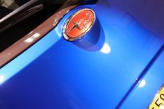 an emblem on the side of a blue car