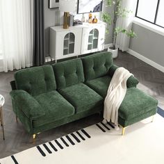 a green couch sitting on top of a white rug