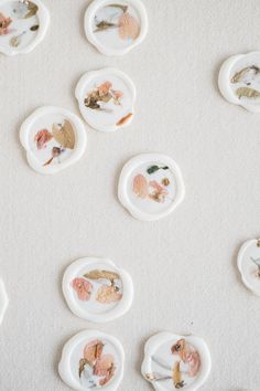 several plates with different designs on them sitting on a white tablecloth covered flooring