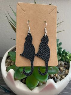 -cat shaped earrings  -made out of very lightweight leather.  -leather is black. -perfect for sensitive ears. -nickel free. -great gift. - great for cat lovers. leather tooled  earrings - pierced leather - black earrings - leather earrings - cats- dangle - gift  - valentines gift  - fun jewelry - dangle earrings - cat- cat earrings - cute earrings Black Leather Earrings As A Gift, Handmade Black Faux Leather Jewelry, Adjustable Black Faux Leather Earrings, Tooled Earrings, Pet Earrings, Fun Jewelry, Animal Earrings, Cat Earrings, Earrings Black