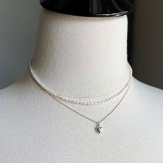 "There are 2 necklaces in this listing.   Necklace 1:   Sterling silver puff heart hangs from a tiny curb chain in bright 925 sterling silver. Details of Necklace 1: - Length of the necklace - 16\" with the option to add a 1.5\" extender chain - Dainty sterling silver curb chain (approx 1mm) & sterling silver lobster trigger clasp - Dainty puff heart in sterling silver - 6X9mm Necklace 2:  Tiny white freshwater pearl necklace with sterling silver lobster clasp.  Details of Necklace 2: - Length o Dainty Heart Necklace, Tiny Heart Necklace, White Pearl Necklace, Puffed Heart, Silver Heart Necklace, Tiny Heart, White Freshwater Pearl, Pearl Choker, Freshwater Pearl Necklaces