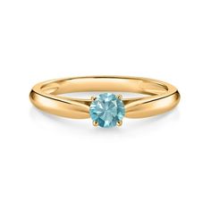 a yellow gold ring with an aqua blue topazte stone in the center, on a white background