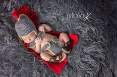 a baby wearing a crochet hat and diaper is laying on a blanket