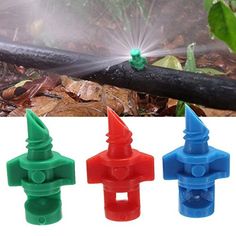 the sprinkler is spraying water on the plants in the garden, and three different colors are shown