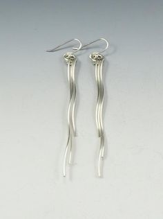 Sterling silver spiral earrings. These are a graceful design that measure 2" in length and hang from sterling ear wires. Rubber stoppers are also supplied with each pair for security.Created from responsibly sourced materials where possible. Each piece is handmade, because of this there may be slight variations in your finished piece from the photo shown. Please allow 1-2 weeks for fabrication and delivery.Free shipping is only available in Canada and United States. International customers, plea Modern Twist Silver Jewelry With Ear Wire, Modern Twist Sterling Silver Jewelry With Ear Wire, Modern Spiral Earrings With Ear Wire, Modern Twist Dangle Earrings With Ear Wire, Modern Twist Silver Spiral Earrings, Nickel-free Modern Twist Dangle Earrings, Nickel-free Dangle Earrings With A Modern Twist, Modern Twist Nickel-free Dangle Earrings, Modern Twist Nickel-free Drop Earrings