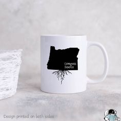 a white coffee mug with the oregon roots on it