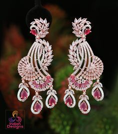 These Rose Gold Polish American Diamond CZ Stone Studded Drop Dangle Earrings are the epitome of luxury and style. Perfect for party wear, these earrings are inspired by Celebrity and Indian Bollywood styles. The Diamond Look CZ Diamond color stones are arranged in a unique peacock design, making these earrings a true work of art from Indian designs. Add a touch of glamour to any outfit with these stunning earrings. American Diamond Earrings, Blue Diamond Earrings, Bridal Statement Earrings, Peacock Earrings, Party Kleidung, Bollywood Jewelry, Peacock Design, Design Earrings, Stone Studs