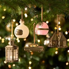 ornaments hanging from a christmas tree with lights in the background and a car ornament