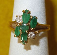 A Vintage 1980's Emerald & Diamond 14 Karat Gold Cocktail Ring (Size 4). Visit our shop for awesome retro photos, vintage jewelry, sports memorabilia and home decor. Size: 4 Material: 14 Karat Gold/Emerald/Diamond  Condition: Excellent.  Weight: 2.3 DWT Year: 1980's Signed: Unsigned.  Inventory #: 1771 Retro Photos, Emerald Ring Vintage, Emerald Rings, Gold Cocktail Ring, Gold Cocktail, Photos Vintage, Retro Photo, Emerald Jewelry, Emerald Diamond