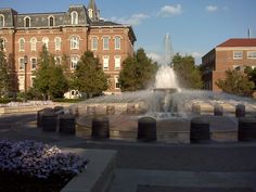 a water fountain in front of a large building