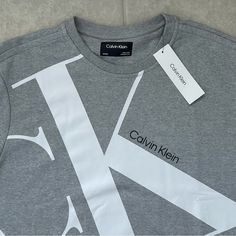 Calvin Klein Men's Ck Sweatshirt Heroic Grey Heather Size: Xl Brand New Calvin Klein Big Ck Logo On Front For An Iconic Design Super Soft, Loungewear Comfort Crewneck And Long Sleeves Ribbed Knit Cuffs, Waistline, And Collar Product Details: With An Iconic Logo Styling Front, This Calvin Klein Sweatshirt Features A Plush Cotton Knit Blend For Premium Comfort. Finished With A Crewneck, Long Sleeves And Ribbed Knit Trim For A Snug Fit. A Fashion Essential, This Calvin Klein Pullover Is A Versatile Casual Short Sleeve Sweatshirt With Logo Print, Calvin Klein Crew Neck Top With Logo Print, Calvin Klein Logo Print Crew Neck Top, Calvin Klein Long Sleeve Logo Print Tops, Calvin Klein Long Sleeve Tops With Logo Print, Calvin Klein White T-shirt For Streetwear, Calvin Klein Crew Neck Sweatshirt With Letter Print, Calvin Klein Relaxed Fit Logo Print Top, Calvin Klein Crew Neck Sweatshirt For Streetwear