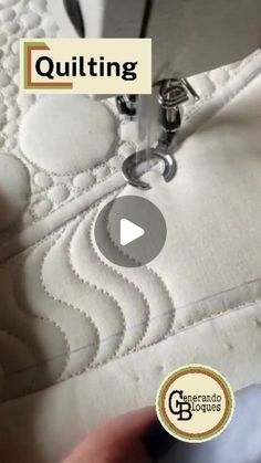 someone is stitching on the side of a quilt