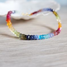 This rainbow bracelet has a great variety of natural gemstones. They are : Aquamarine, Tourmaline, Garnet, Ruby, Carnelian, Citrine, Peridot , Tanzanite, Apatite, And iolite A gorgeous fusion of colors in this multi stone precious  bracelet. A riot of vivid  colors  in ombre design I chose and  lined the gemstones to obtain this unique shaded colorful precious bracelet. It will be beautiful alone or together with other gemstones stacking bracelets The gemstone beads are strung on the highest qua Rainbow Gemstone Beaded Bracelet, Rainbow Gemstone Beads Bracelet, Multicolor Gemstone Beaded Bracelets For Jewelry Making, Multicolor Gemstone Beads, Rainbow Natural Stones Beaded Bracelets For Jewelry Making, Multicolor Rondelle Bracelets For Jewelry Making, Handmade Multicolor Gemstone Bracelet, Multicolor Gemstone Crystal Bracelet, Spiritual Multicolor Faceted Beaded Bracelets