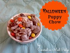 a bowl filled with candy corn and puppy chow