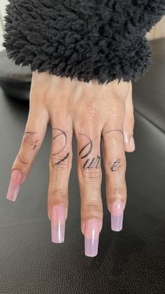 a woman's hand with tattoos on it