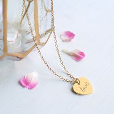 Perfect for Valentine's Day or for the bride on her big day, our beautiful gold heart necklace has the word 'love' in a script font engraved on the front. It can be personalised on the reverse with a date or wording to make it truly unique and would also make a gorgeous gift idea for a birthday or a wedding anniversary. Made from gold plated 925 sterling silver. Please tell us the text (maximum 6 characters) you would like engraved on the reverse of your necklace in the 'Notes to Seller' during checkout.  Available in 5 lengths: 43cm, 50cm, 60cm, 70cm. Heart measures 1.5cm x 1.5cm. A Floradora gift packet with tissue paper and a sticker is provided with every item of jewellery. Care instructions:  Polish gently with a soft cloth to maintain the shine of your jewellery.  Please don't wear w Rose Gold Name Necklace For Wedding Gift, Heart Cut Heart Necklace For Mother's Day Wedding, Heart Cut Heart Necklace For Wedding On Mother's Day, Heart Cut Necklace For Wedding And Mother's Day, Heart Cut Necklace For Wedding And Valentine's Day, Valentine's Day Wedding Necklace Heart Cut, Valentine's Day Gift Heart Necklace With Delicate Chain, Heart Charm Jewelry For Wedding On Valentine's Day, Rose Gold Heart Necklace For Wedding On Valentine's Day