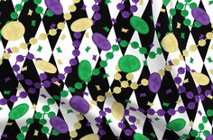 a black and white background with purple, green and gold confetti on it