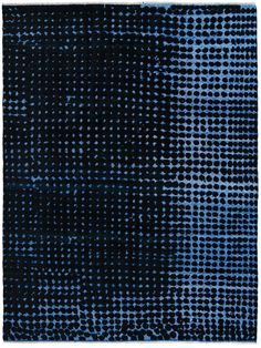 a blue and black area rug with small dots on the top, in an irregular pattern