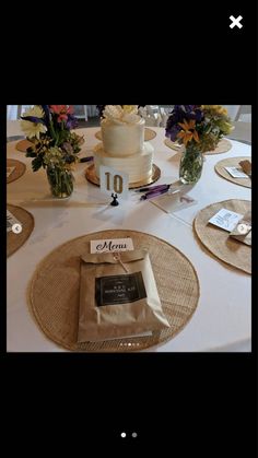 a table topped with a white cake covered in frosting