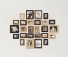 a group of framed pictures hanging on the side of a wall with multiple frames around them