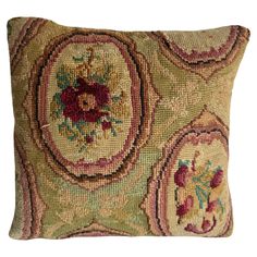 a decorative pillow with an oval design on the front and side, made from multicolored wool