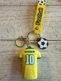 a keychain with a soccer jersey on it and a name tag attached to it