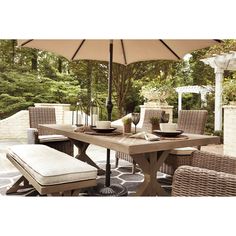 an outdoor dining table with chairs and umbrella