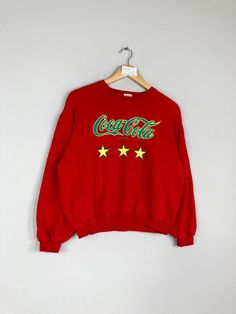 Vintage Rare COCA COLA Women Cropped Crewneck Sweatshirt Big Logo Coca Cola Jumper Pullover Coca Cola Sweater Red Colour Large Size CONDITION :- ✅GOODUSED CONDITION. ✅NO STAINS  ✅NO HOLE ITEM DESCRIPTION:- ✅SIZE: 160 ✅MATERIAL : COTTON ✅THIS USED & VINTAGE ITEMS, SO DON'T EXPECTED IT TO BE LIKE NEW CONDITION!! MEASUREMENT: ✅ARMPIT TO ARMPIT : 21.5 INCH ✅LENGHT NECK TO : 20.5 INCH  ✅SHOULDHER : 21 INCH ✅SLEEVE: 18.5 INCH PLEASE REFER PHOTO BEFORE ORDER √ALL MEASUREMENTS ARE TAKEN WITH THE GARMENT FLAT ON THE GROUND √WE SHIP BY POST VIA MALAYSIA INTERNATIONAL REGISTERED/SIGNED FOR WITH TRACKING NO. TRACKING NUMBER WILL BE GIVEN. √THE PARCEL WILL BE ARRIVE WITHIN 10-14 WORKING DAYS OR MORE DUE TO THE LOCATION & CUSTOMS CLEARINGS. √BUYER DON'T HESITATE TO ASK ME IF ANY INQUIRY ABOUT ITEM BEFOR Vintage Red Crew Neck Tops, Red Long Sleeve Sweatshirt, Retro Crew Neck Tops For Winter, Red Vintage Crew Sweater, Red Graphic Print Crew Neck Sweater, Vintage Red Crew Neck Sweater, Red Crew Neck Sweater With Graphic Print, Retro Red Long Sleeve Sweatshirt, Red Retro Long Sleeve Sweatshirt